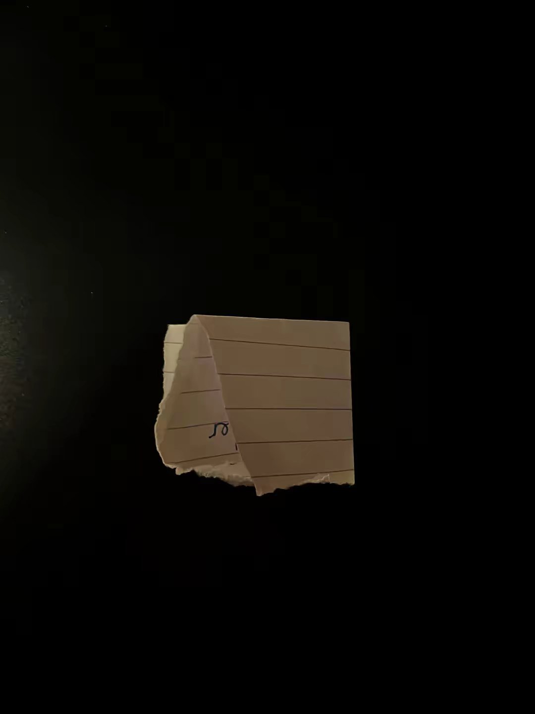 Partial handwritten note hidden under folded paper
