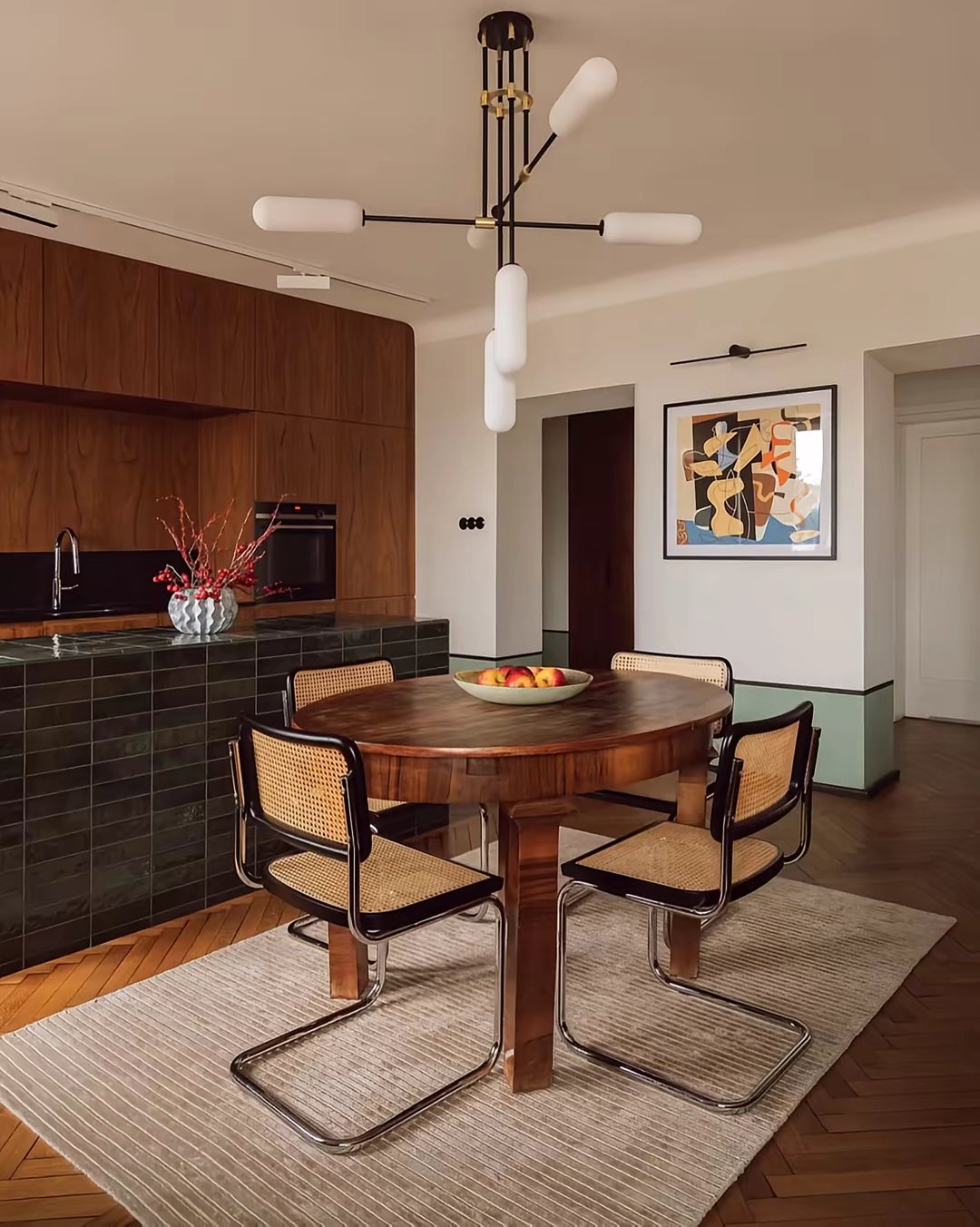 No text; image-only warm wood and sage interior tour.